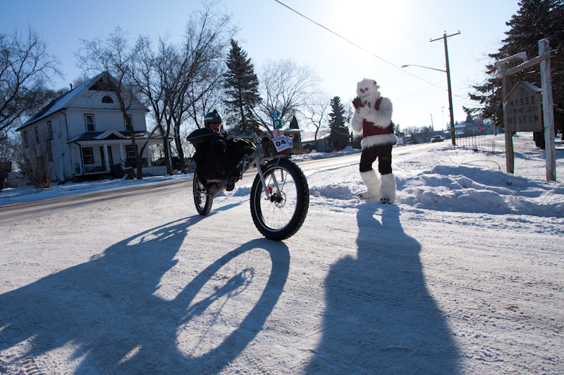 "Mani" the Manitoba Yeti and Actif Epica mascot cheers for a recumbent fatbike rider during the 2012 race in Winnipeg, Canada. Photo by Kyle Thomas. 