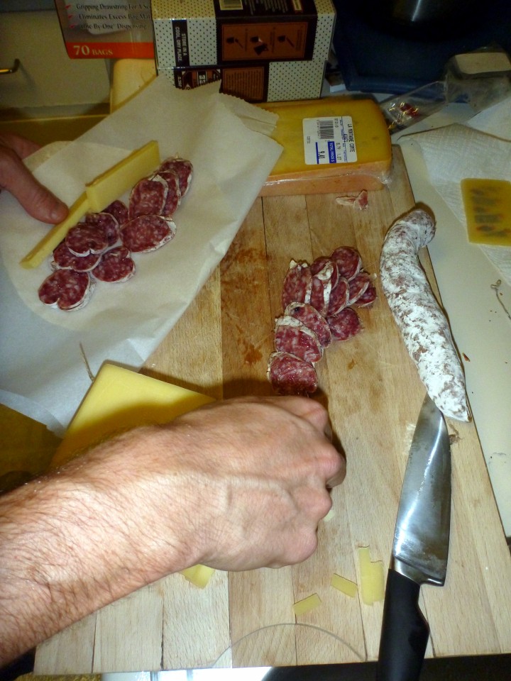 Preparing salami and cheese tortillas for a tasty Iditarod dinner.